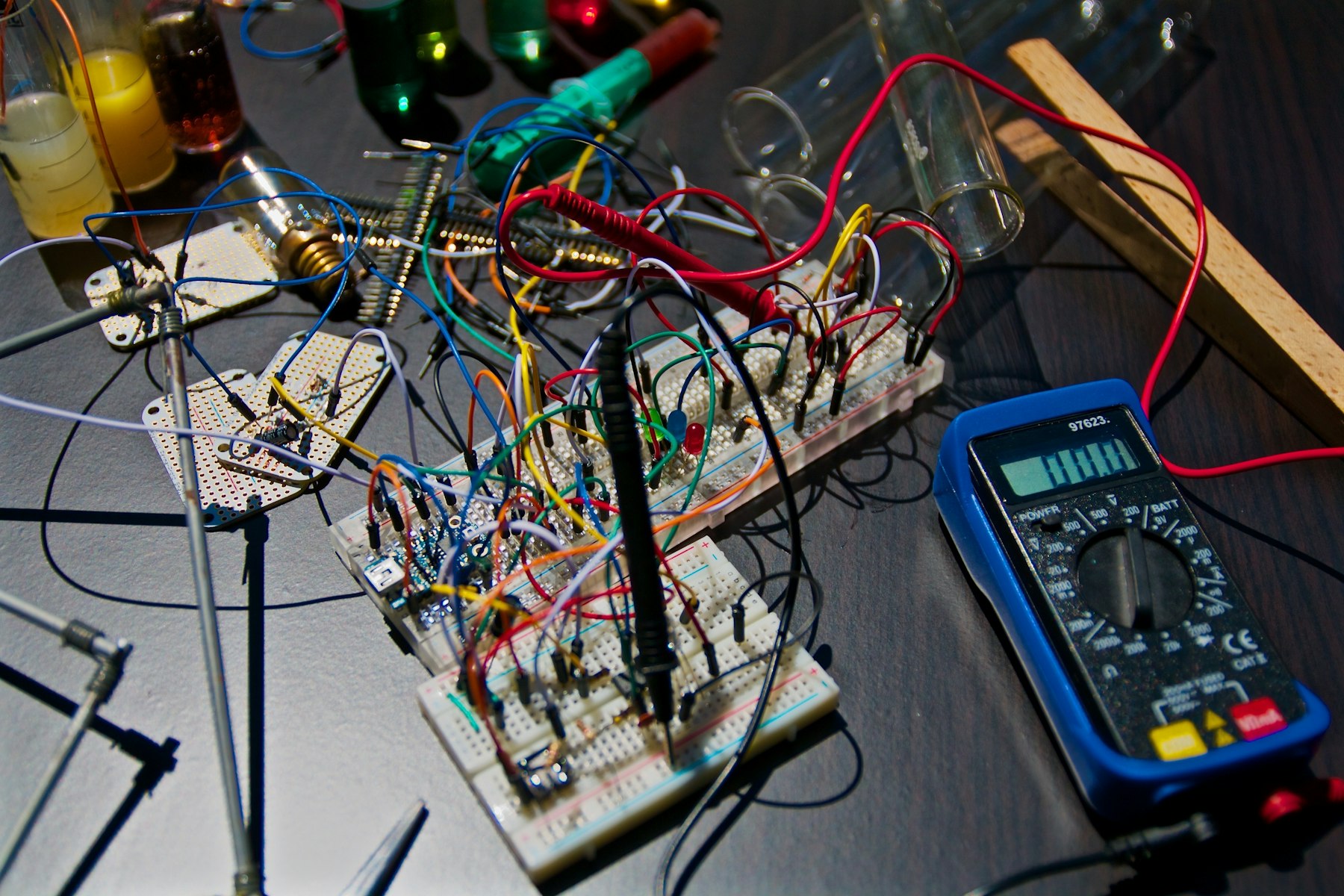Hands-on electronics workbench with a breadboard and multimeter